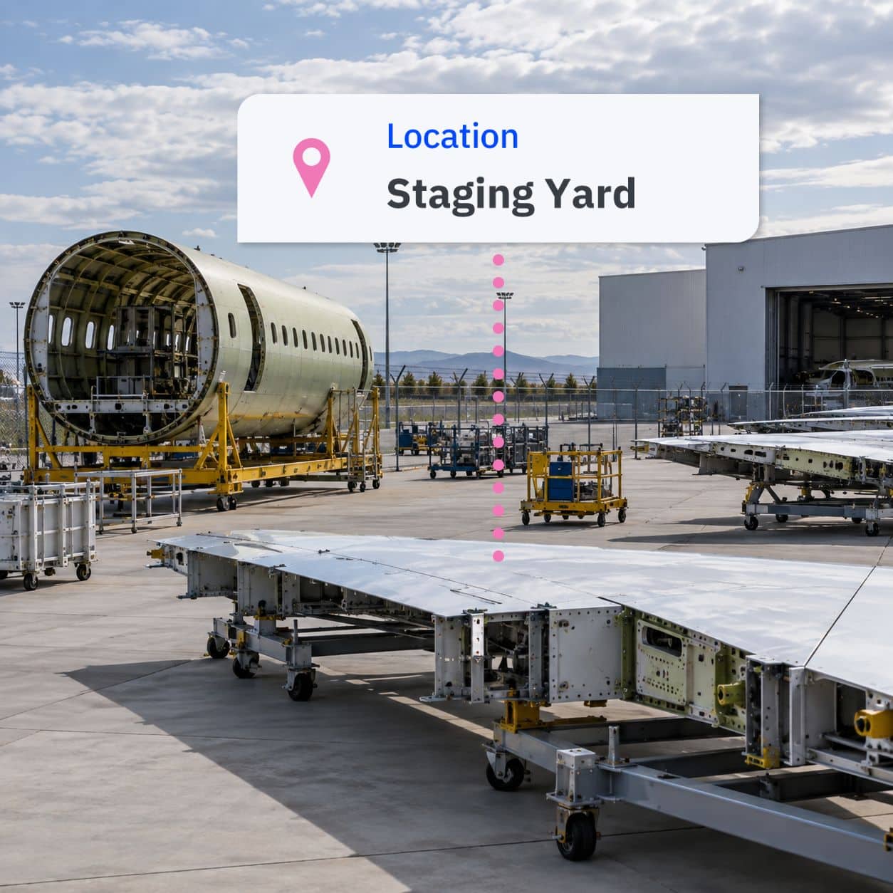 aerospace-staging-yard-v02 Aircraft fuselage section, wing assemblies, and ground support equipment staged outside an aerospace manufacturing facility.